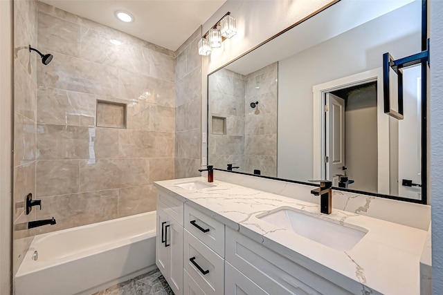 bathroom with vanity and tiled shower / bath