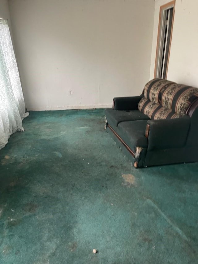 sitting room with dark colored carpet