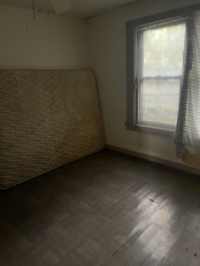 spare room with hardwood / wood-style floors and plenty of natural light