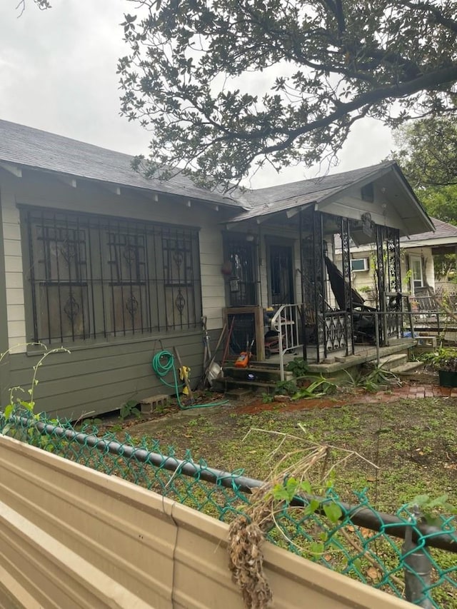 back of property with a porch