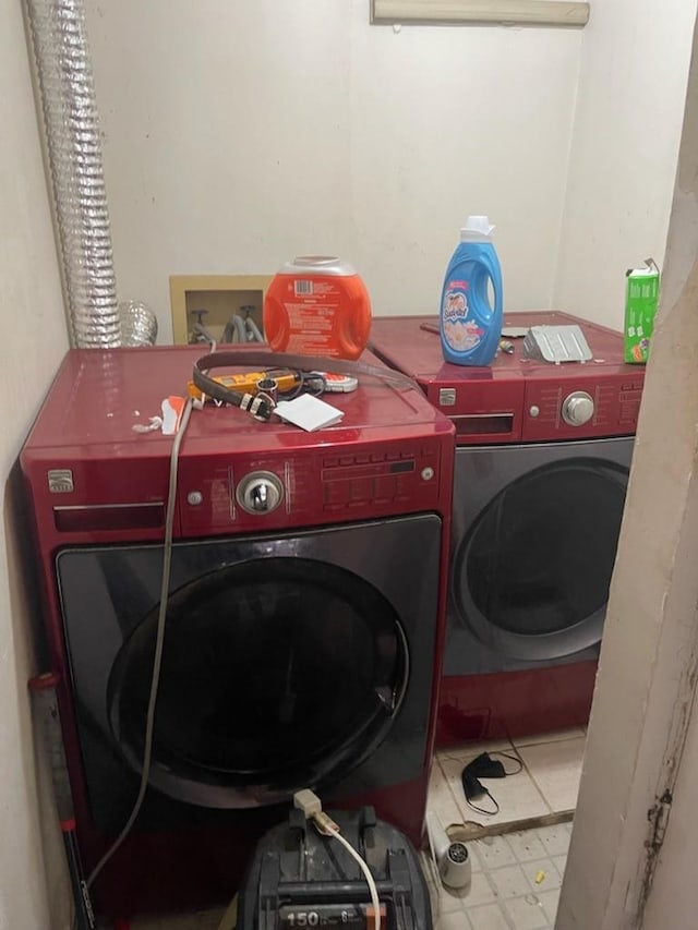 clothes washing area featuring washer and clothes dryer