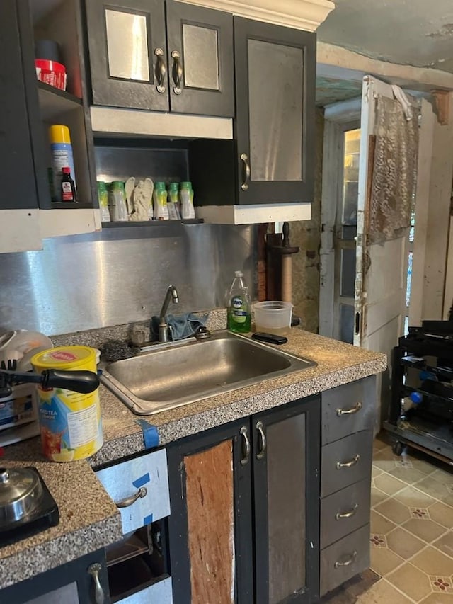 kitchen featuring light tile patterned flooring and sink