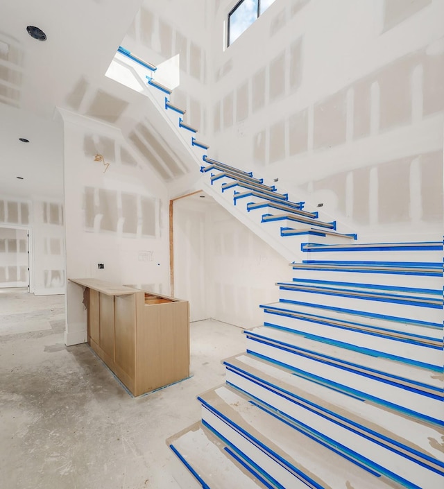 stairway with concrete flooring