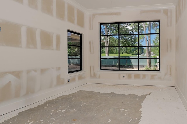 unfurnished room featuring crown molding