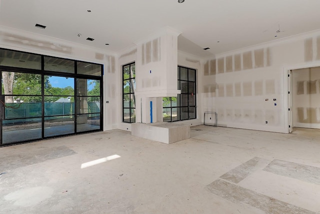 unfurnished living room with ornamental molding