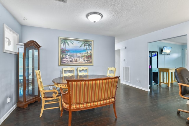 dining area featuring a textured ceiling and dark hardwood / wood-style floors