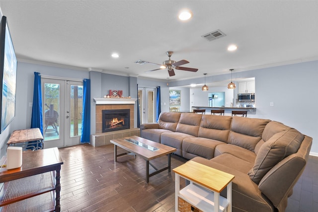 living room with french doors, dark hardwood / wood-style floors, ceiling fan, and ornamental molding