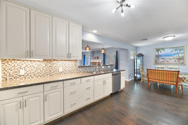 kitchen with pendant lighting, dishwasher, sink, dark hardwood / wood-style floors, and white cabinetry