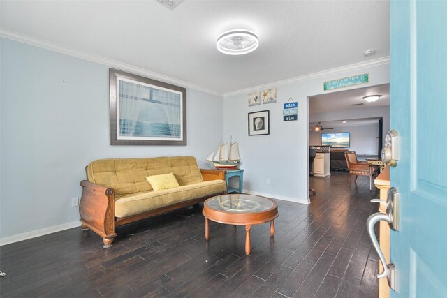 living room with dark hardwood / wood-style floors, ceiling fan, and ornamental molding