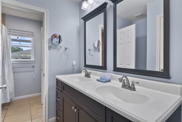 bathroom featuring tile patterned flooring and vanity