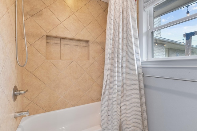 bathroom with shower / bath combination with curtain