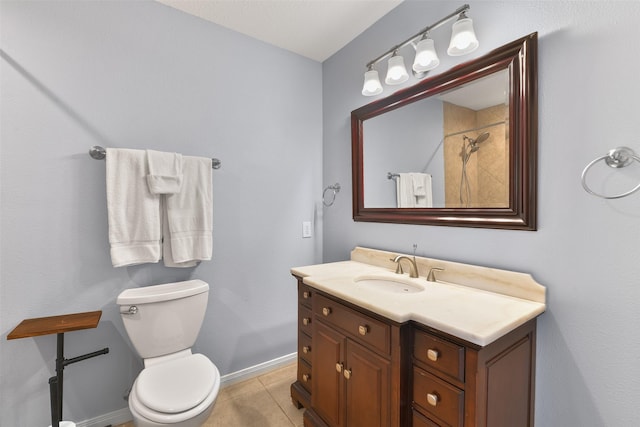 bathroom featuring tile patterned flooring, vanity, and toilet