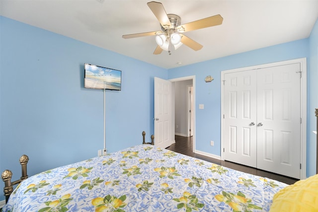 bedroom featuring ceiling fan, a closet, and dark hardwood / wood-style floors