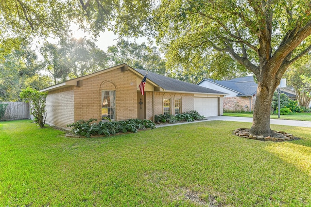 single story home featuring a garage and a front lawn