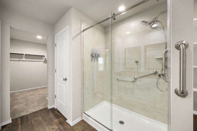 bathroom featuring hardwood / wood-style flooring and an enclosed shower