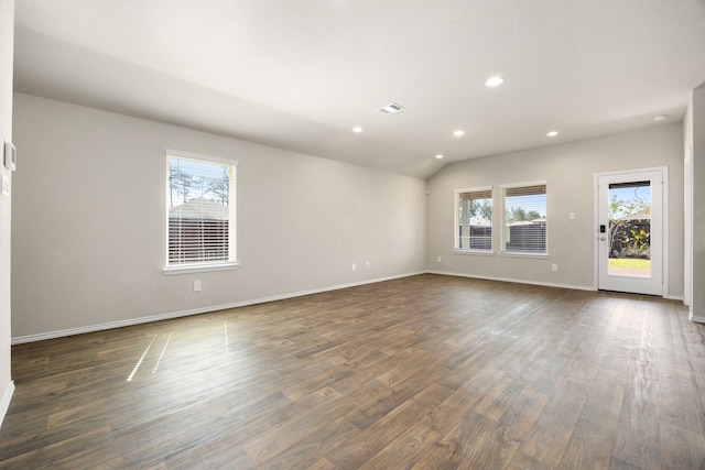 unfurnished room with dark hardwood / wood-style flooring and vaulted ceiling