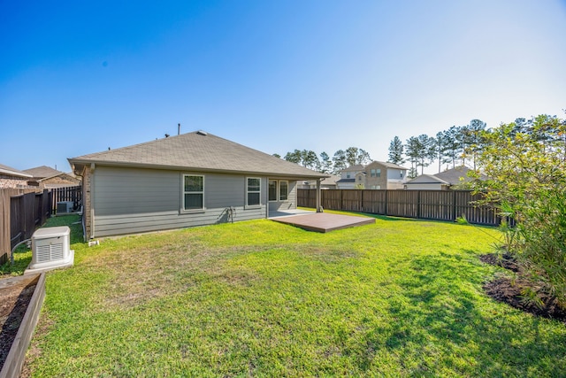 rear view of property featuring a yard