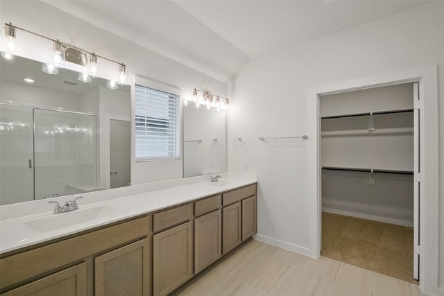 bathroom featuring vanity and a shower with door