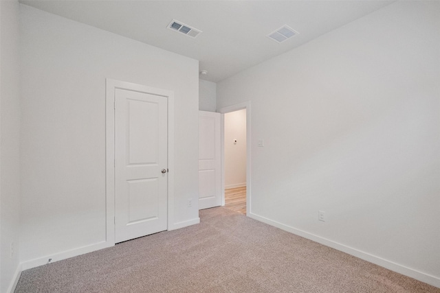 unfurnished bedroom with light carpet