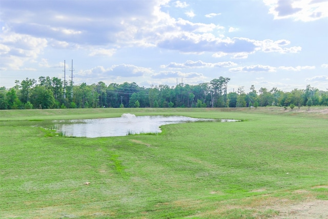 view of home's community with a water view and a lawn