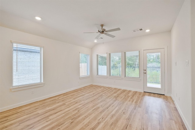 empty room featuring ceiling fan, light hardwood / wood-style flooring, and vaulted ceiling