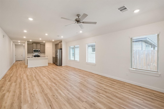 unfurnished living room with light hardwood / wood-style flooring and ceiling fan