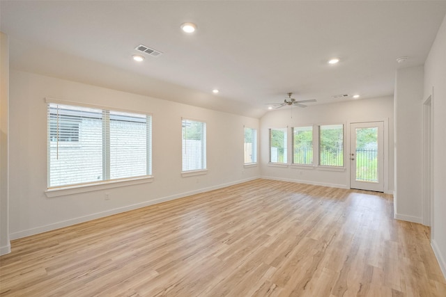 empty room featuring ceiling fan, light hardwood / wood-style floors, and vaulted ceiling