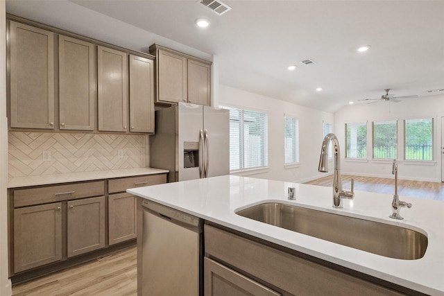 kitchen with dishwasher, sink, ceiling fan, white fridge with ice dispenser, and tasteful backsplash