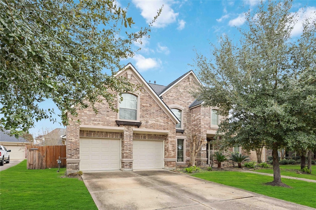 view of front of property with a garage and a front lawn