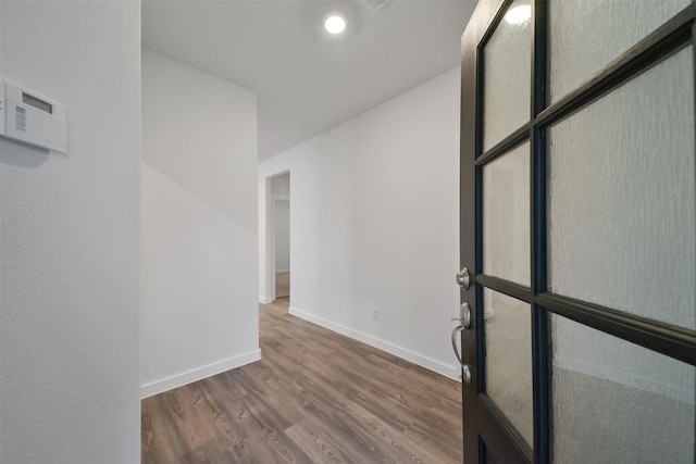 unfurnished room with hardwood / wood-style flooring