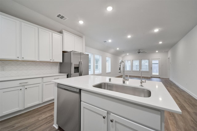 kitchen featuring appliances with stainless steel finishes, sink, a center island with sink, and white cabinets