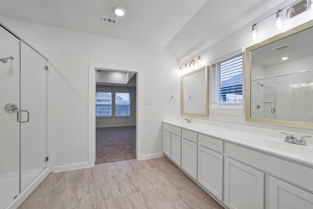 bathroom with vanity and a shower with shower door