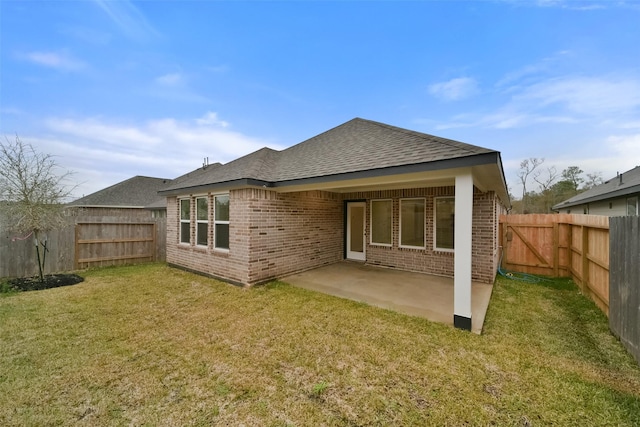 back of house featuring a yard and a patio area