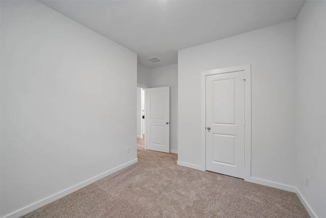 unfurnished bedroom featuring light colored carpet