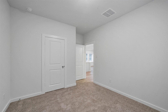 unfurnished bedroom with light colored carpet