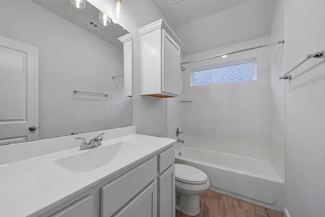 full bathroom with shower / bath combination, vanity, wood-type flooring, and toilet