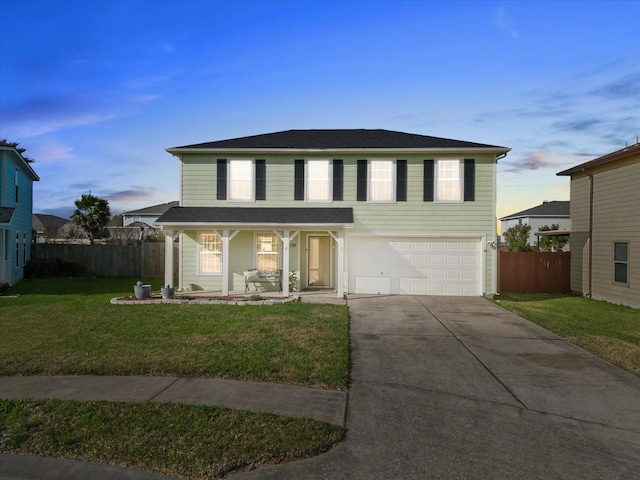 view of front facade featuring a lawn, a porch, and a garage