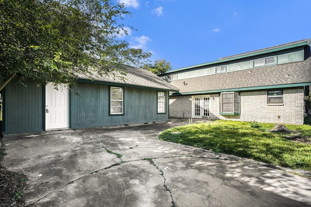 rear view of house with a yard