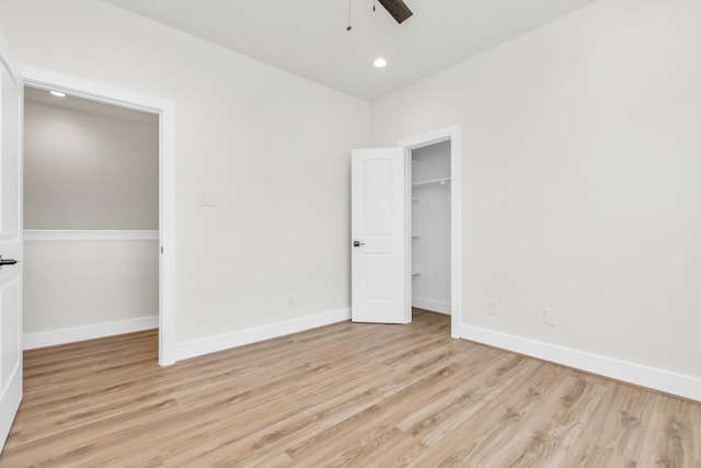 unfurnished bedroom featuring ceiling fan, a closet, and light hardwood / wood-style flooring