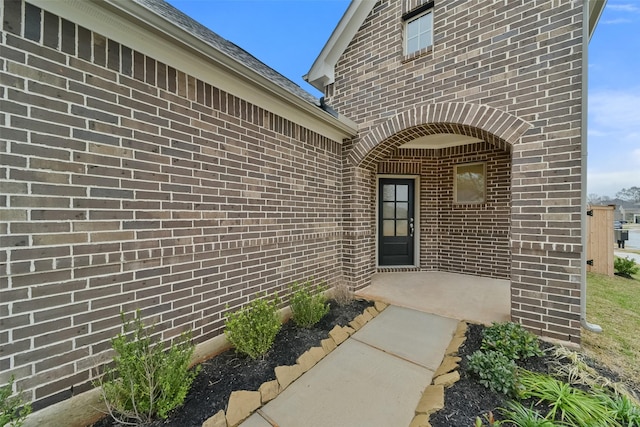 view of exterior entry featuring a patio area