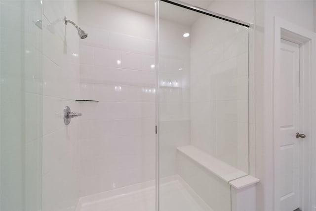 bathroom with a shower with door