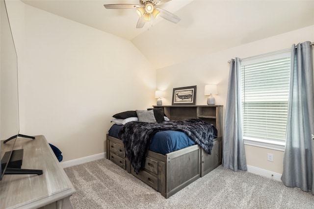 carpeted bedroom featuring multiple windows, ceiling fan, and vaulted ceiling