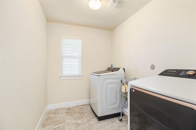 washroom featuring independent washer and dryer