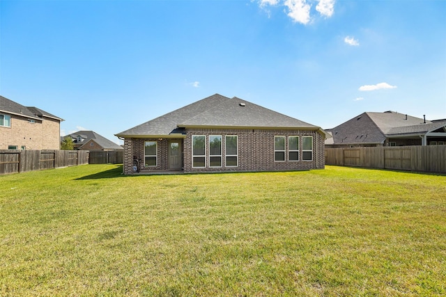 rear view of property featuring a lawn