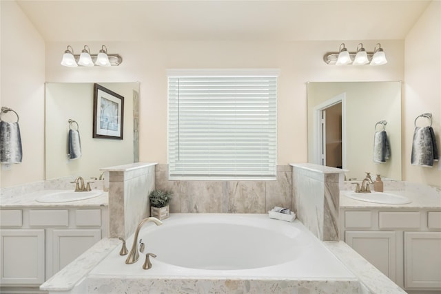 bathroom with tiled tub and vanity