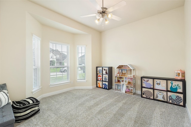 recreation room with carpet floors and ceiling fan