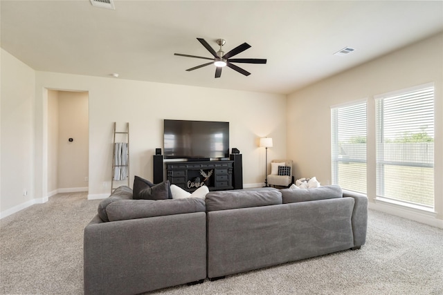 carpeted living room featuring ceiling fan