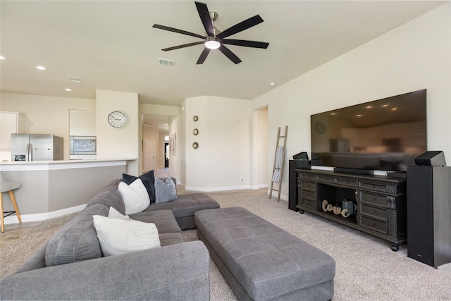 living room featuring ceiling fan and light colored carpet