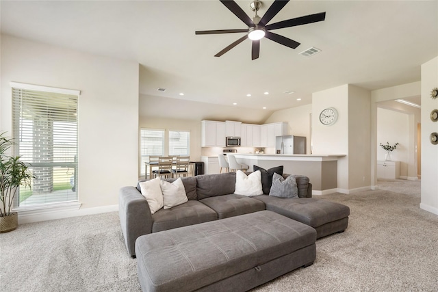 living room with light carpet, ceiling fan, and lofted ceiling