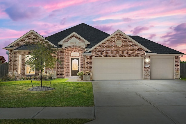 view of front of home featuring a garage and a lawn